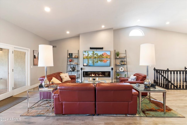 24218 N 85th St, Scottsdale, AZ 85255 - living area featuring vaulted ceiling, a glass covered fireplace, recessed lighting, and wood finished floors