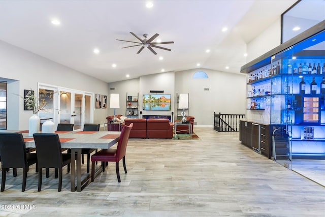 dining space featuring french doors, light wood-type flooring, ceiling fan, and lofted ceiling