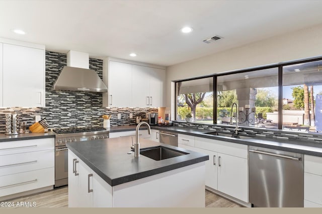 24218 N 85th St, Scottsdale, AZ 85255 - kitchen with wall chimney exhaust hood, appliances with stainless steel finishes, dark countertops, backsplash, and recessed lighting