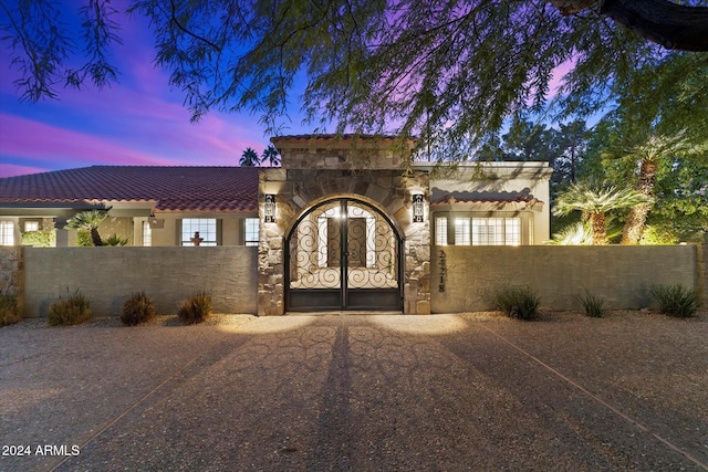 24218 N 85th St, Scottsdale, AZ 85255 - view of front of house with stucco siding, a fenced front yard, driveway, and a tiled roof