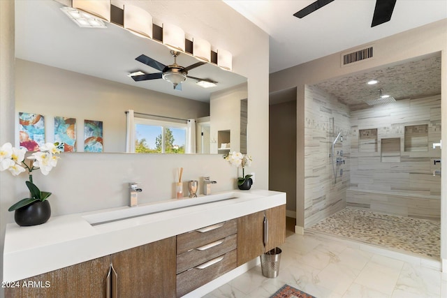 bathroom featuring vanity, ceiling fan, and tiled shower