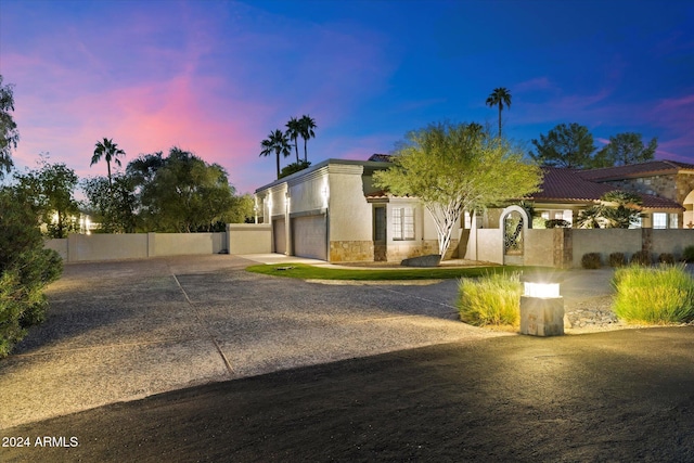 24218 N 85th St, Scottsdale, AZ 85255 - view of front of home with an attached garage, concrete driveway, stone siding, and stucco siding