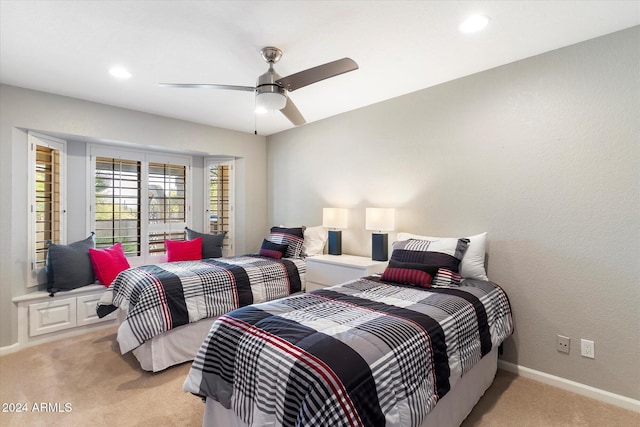 bedroom featuring light carpet and ceiling fan