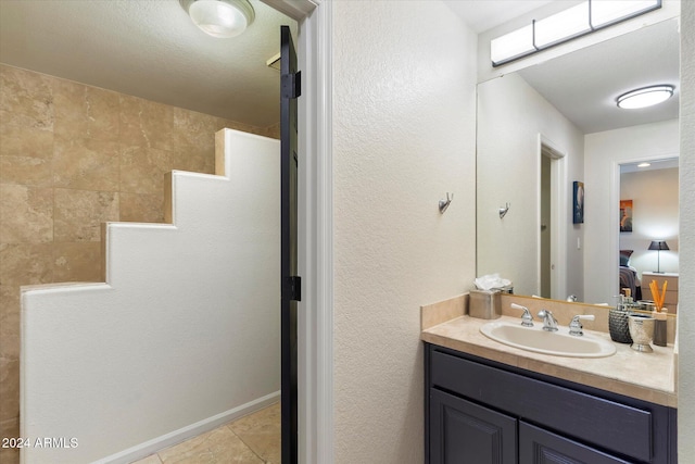 bathroom with vanity, tile patterned floors, and walk in shower