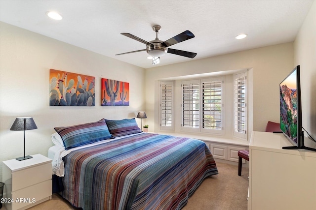 bedroom featuring light carpet and ceiling fan