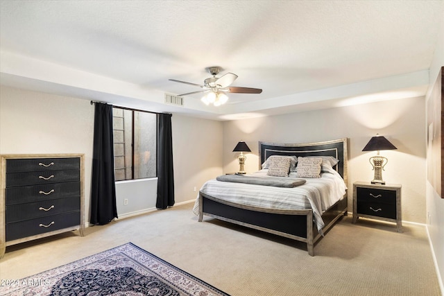 bedroom featuring ceiling fan and light carpet