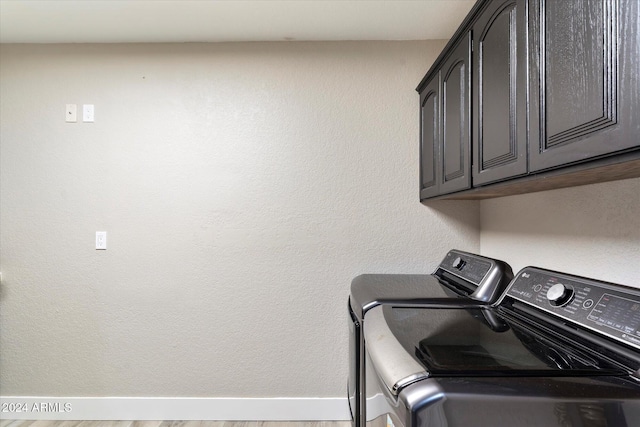 washroom with cabinets and independent washer and dryer