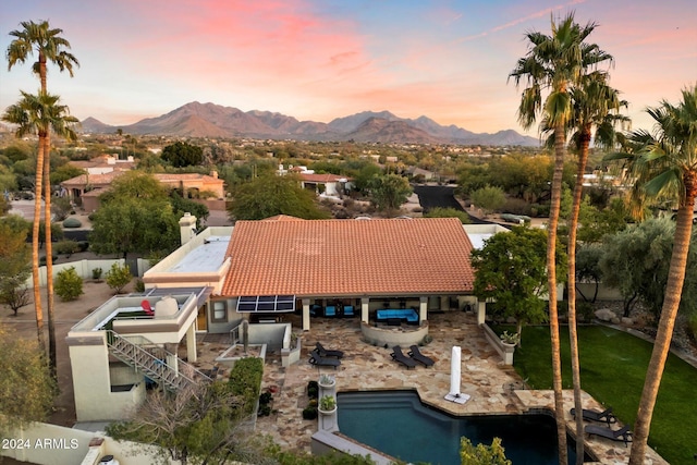 aerial view at dusk featuring a mountain view