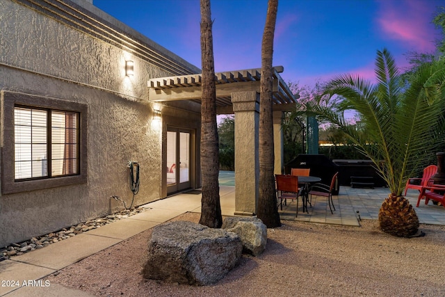 patio terrace at dusk with a pergola