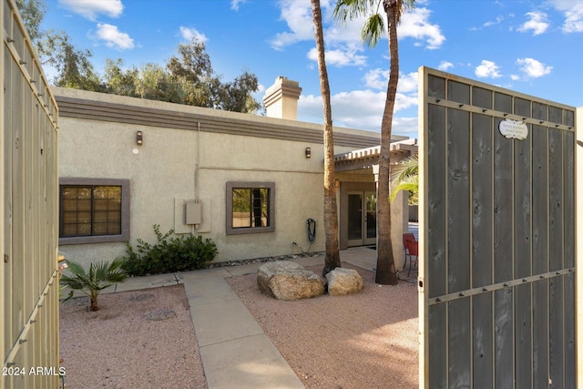 24218 N 85th St, Scottsdale, AZ 85255 - property entrance with stucco siding, a patio area, and a chimney
