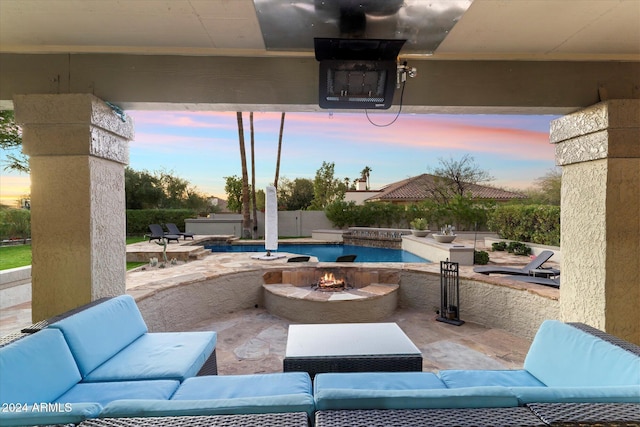 patio terrace at dusk featuring a fenced in pool