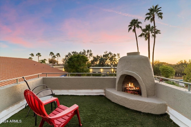 24218 N 85th St, Scottsdale, AZ 85255 - patio terrace at dusk with a balcony and a warm lit fireplace