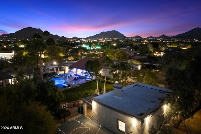 aerial view at dusk featuring a mountain view