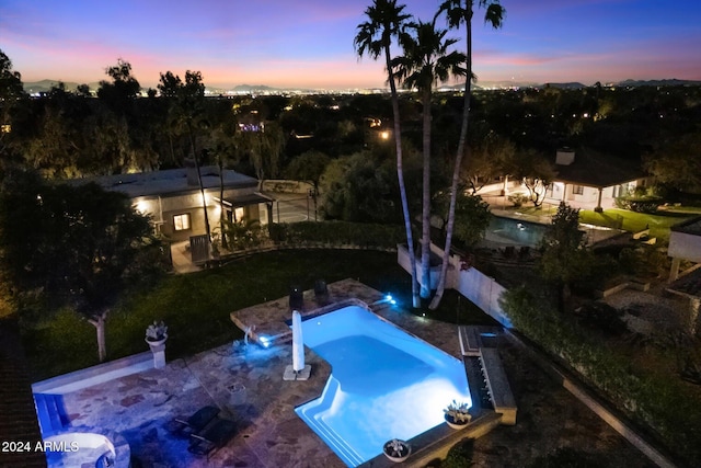 view of pool at dusk