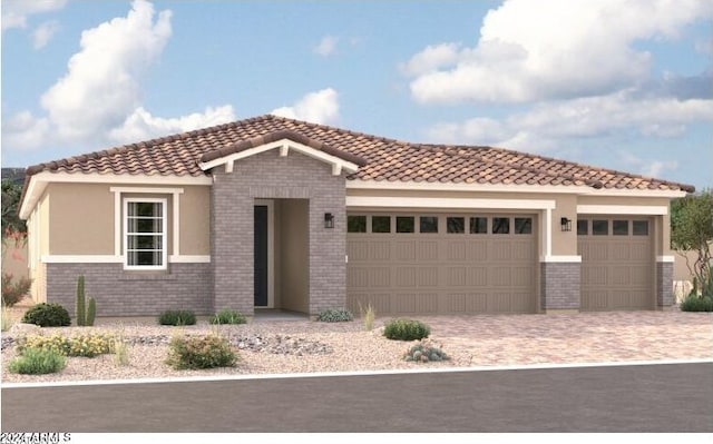 view of front of property featuring an attached garage, a tiled roof, decorative driveway, and brick siding