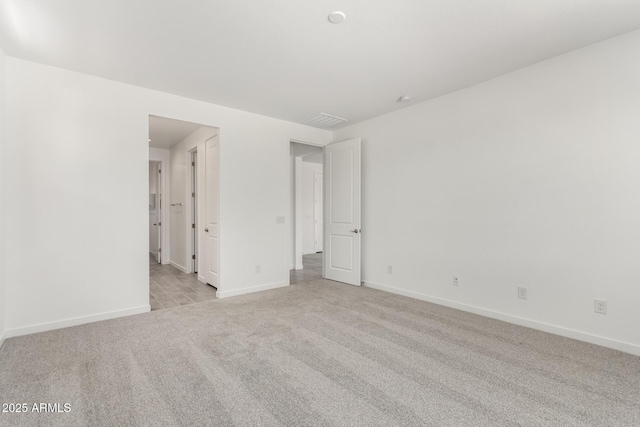 unfurnished bedroom featuring baseboards and carpet flooring