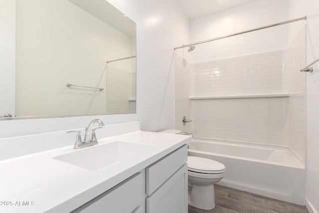 full bathroom featuring toilet, wood finished floors, vanity, and  shower combination