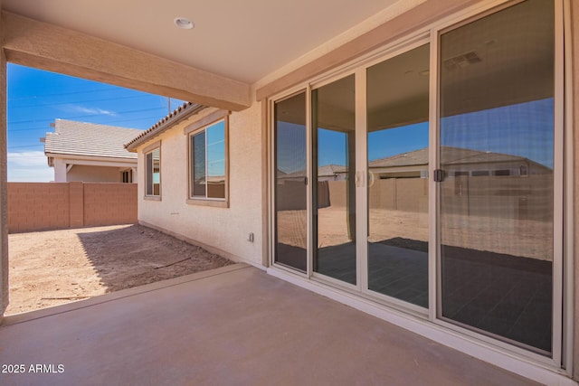 view of patio featuring visible vents and fence