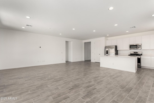 kitchen with recessed lighting, open floor plan, visible vents, and appliances with stainless steel finishes