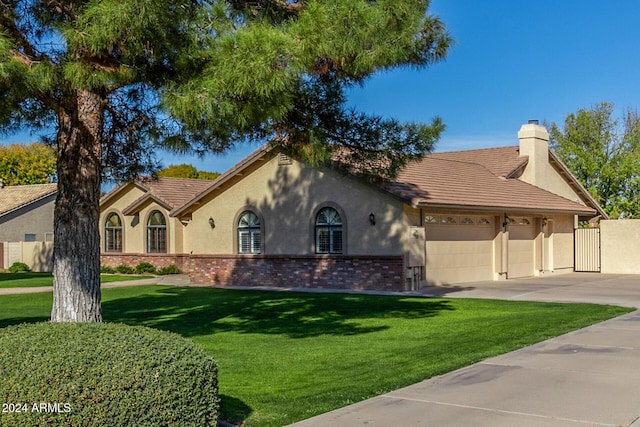 mediterranean / spanish home featuring a garage and a front yard