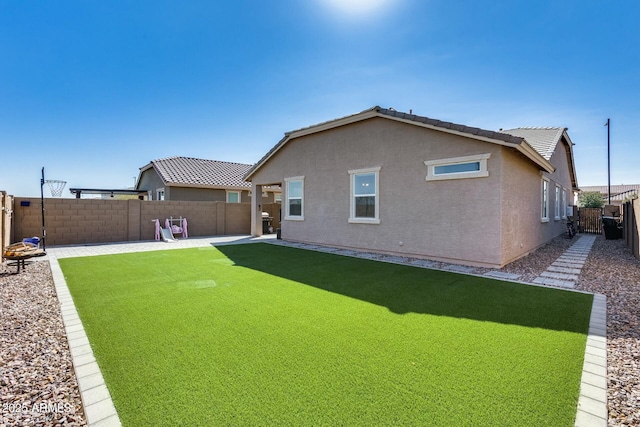 rear view of property with a patio area and a lawn