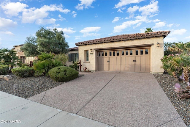 mediterranean / spanish-style house featuring a garage