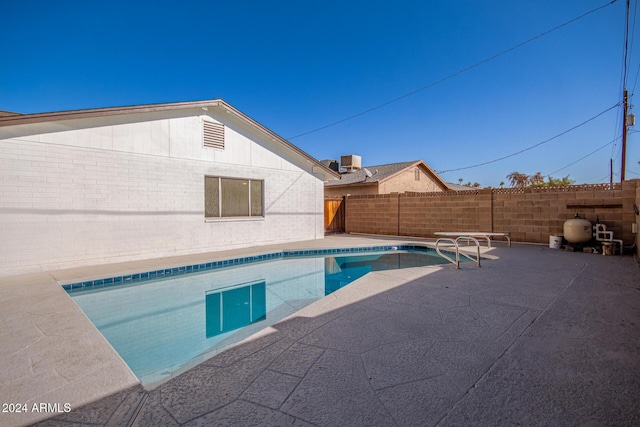 view of pool with a patio and central AC unit