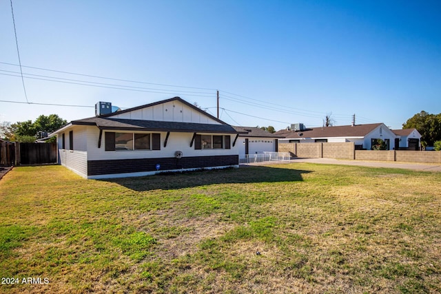 view of front of property featuring a garage and a front lawn