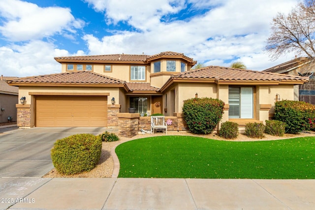 mediterranean / spanish house with stucco siding, an attached garage, driveway, and a front yard