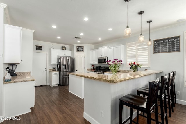 kitchen featuring visible vents, dark wood finished floors, appliances with stainless steel finishes, a peninsula, and white cabinets