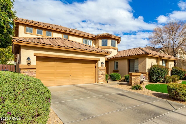 mediterranean / spanish house with stucco siding, stone siding, concrete driveway, and an attached garage