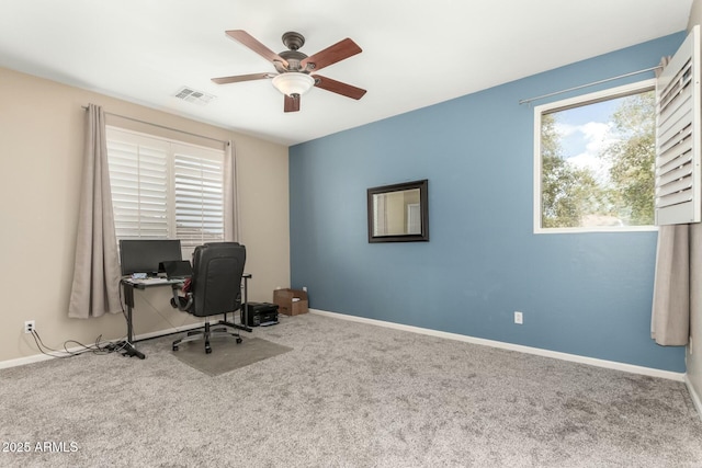 office space with a ceiling fan, carpet, visible vents, and baseboards