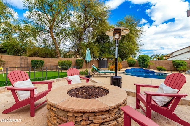 view of patio with a fenced in pool, a fire pit, and a fenced backyard