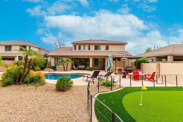 rear view of property with a tiled roof, fence, stucco siding, and a patio area