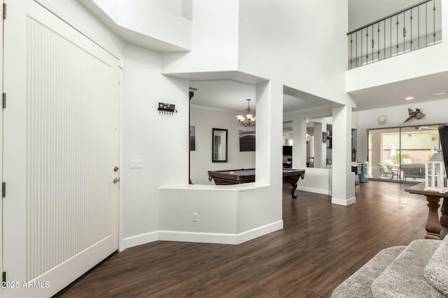 foyer entrance featuring baseboards, dark wood-type flooring, a high ceiling, and billiards