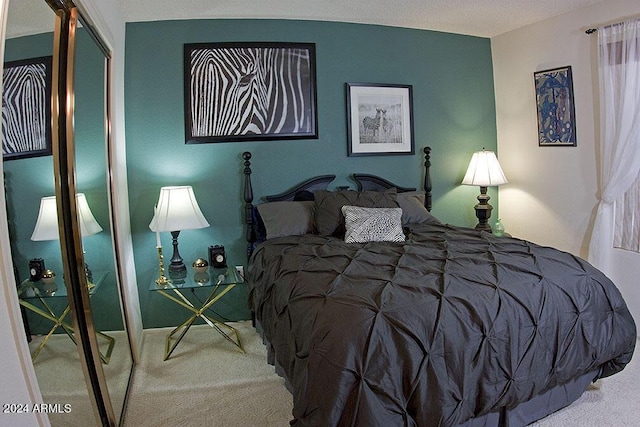 bedroom with carpet and a closet