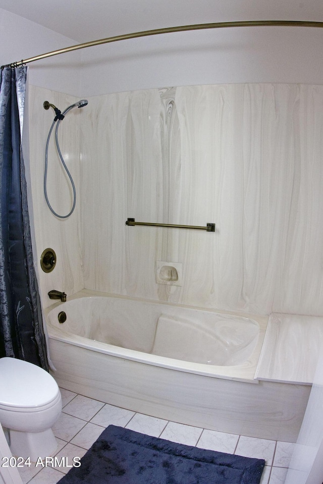 bathroom featuring tile patterned flooring, shower / tub combo with curtain, and toilet