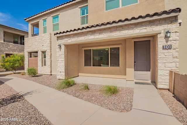 4562 S Park Grove St Unit 101, Gilbert, AZ 85297 - entrance to property featuring stone siding, stucco siding, and a tile roof