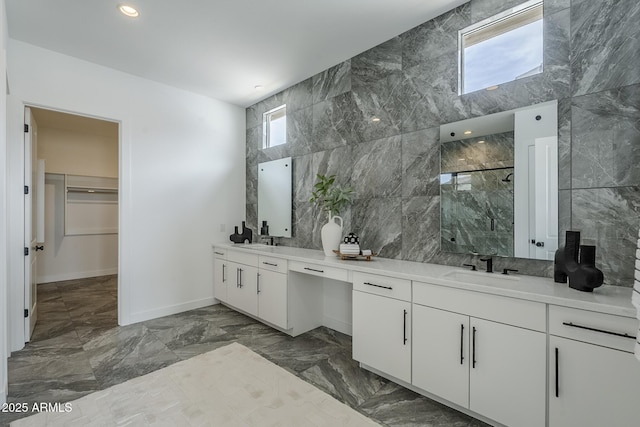 11045 N Hershey St, Surprise, AZ 85388 - bathroom with a marble finish shower, double vanity, tile walls, marble tiled floors, and a walk in closet
