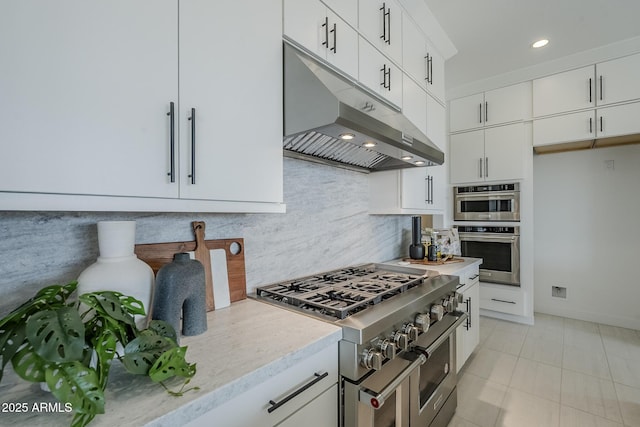 11045 N Hershey St, Surprise, AZ 85388 - kitchen with stainless steel appliances, under cabinet range hood, tasteful backsplash, white cabinetry, and recessed lighting