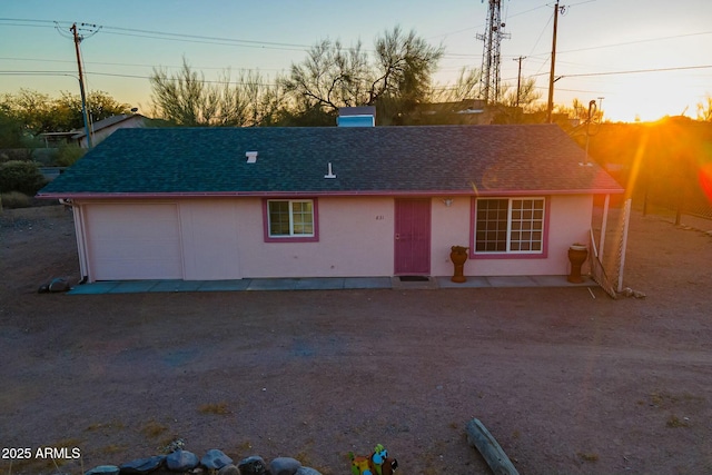 single story home with roof with shingles