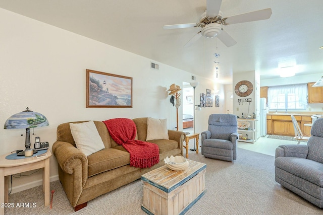 living room with light carpet and ceiling fan