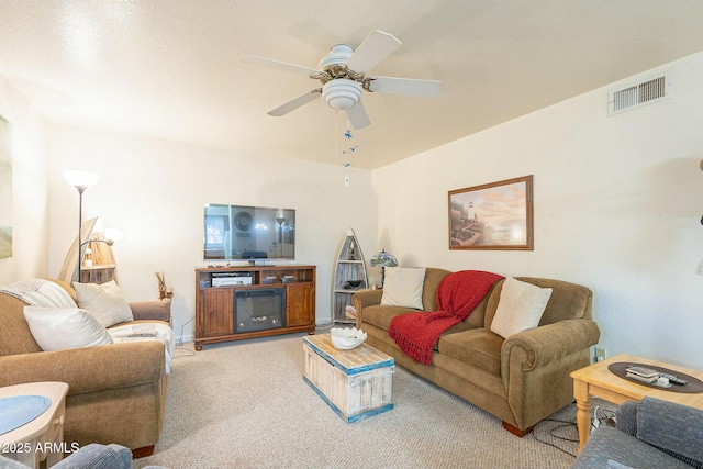 carpeted living room featuring ceiling fan