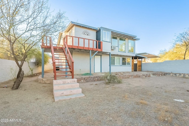 back of house featuring stairway, fence, and a wooden deck