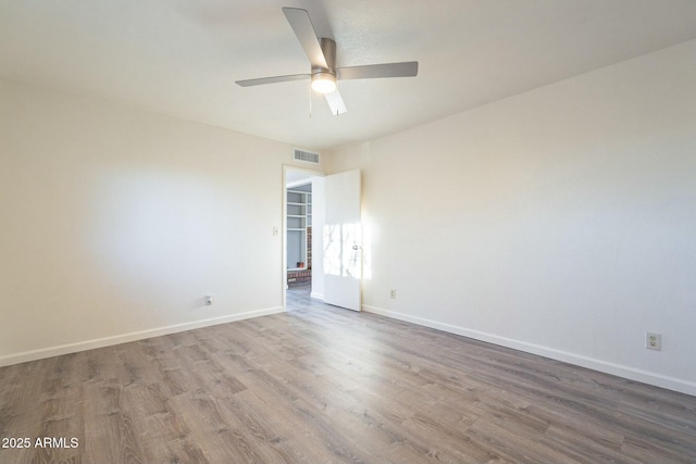 unfurnished room featuring ceiling fan and hardwood / wood-style floors