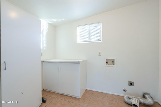 washroom with cabinets, washer hookup, light tile patterned floors, and hookup for an electric dryer