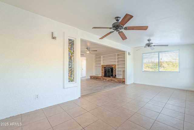 unfurnished living room featuring a brick fireplace, baseboards, built in features, and light tile patterned flooring