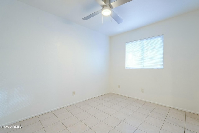 unfurnished room with a ceiling fan and baseboards