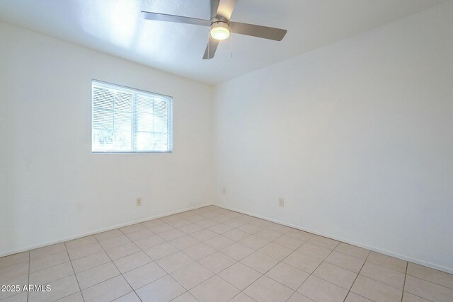 empty room featuring light tile patterned floors and ceiling fan