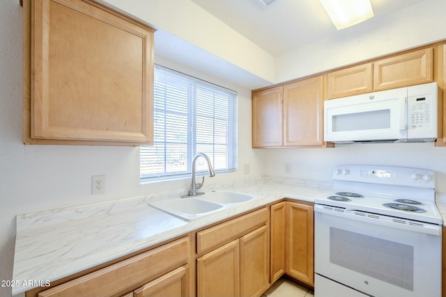 kitchen featuring sink, white appliances, and light brown cabinetry